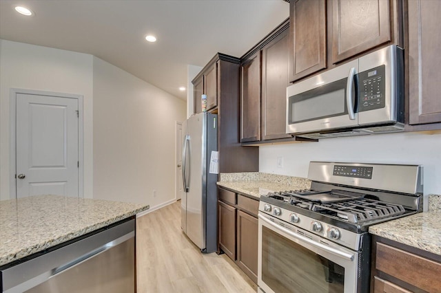 kitchen featuring light hardwood / wood-style floors, dark brown cabinetry, light stone countertops, and appliances with stainless steel finishes