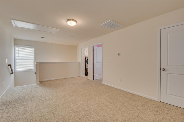 unfurnished room featuring light colored carpet