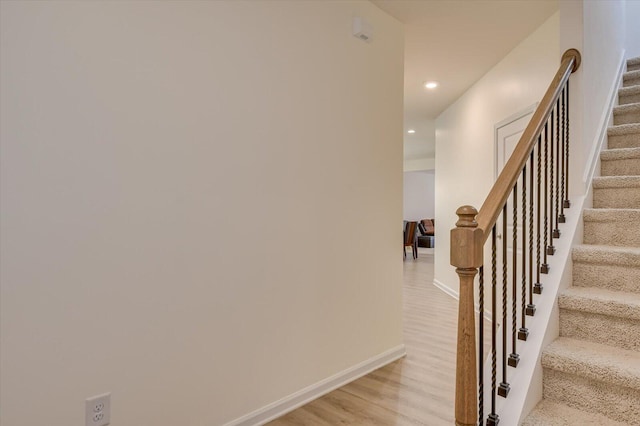 stairs featuring wood-type flooring