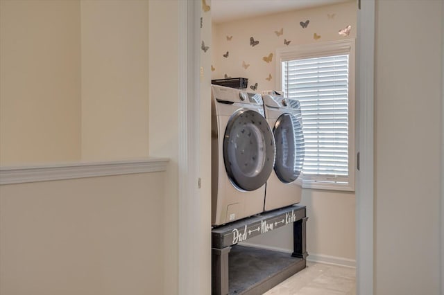 laundry area featuring separate washer and dryer and light tile patterned floors