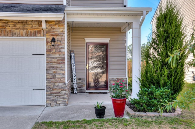 view of exterior entry featuring a garage