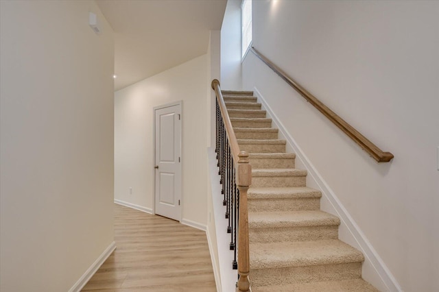 staircase with wood-type flooring