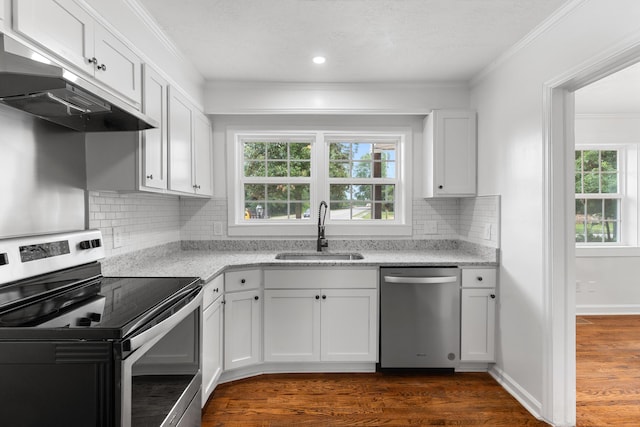411 Warren Rd, Augusta, GA 30907 - kitchen with appliances with stainless steel finishes, under cabinet range hood, dark wood-style flooring, ornamental molding, and white cabinetry