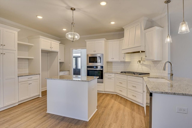 kitchen with decorative light fixtures, appliances with stainless steel finishes, custom range hood, light stone countertops, and white cabinets