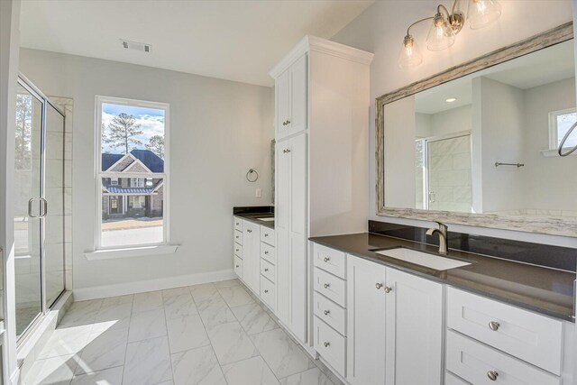 bathroom with vanity, an enclosed shower, and a wealth of natural light