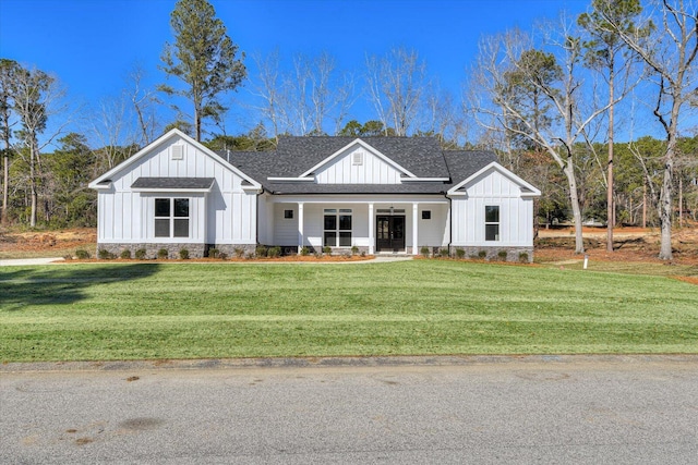 modern farmhouse style home with a front yard and covered porch