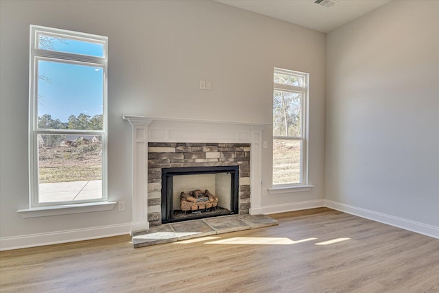 unfurnished living room with hardwood / wood-style flooring and a fireplace