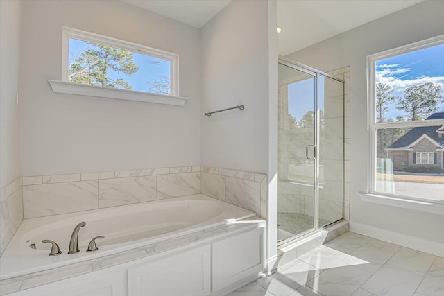 bathroom featuring shower with separate bathtub