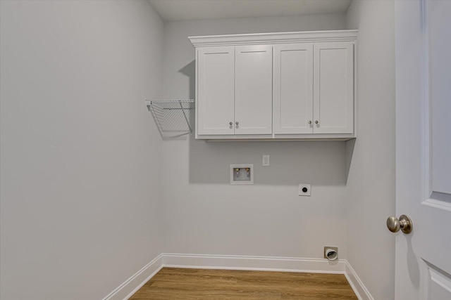 washroom featuring washer hookup, cabinets, hookup for an electric dryer, and light wood-type flooring