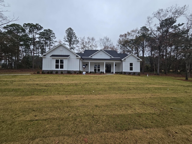 view of front of home with a porch and a front yard