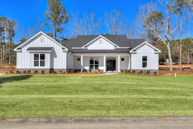 modern inspired farmhouse with a front yard and covered porch