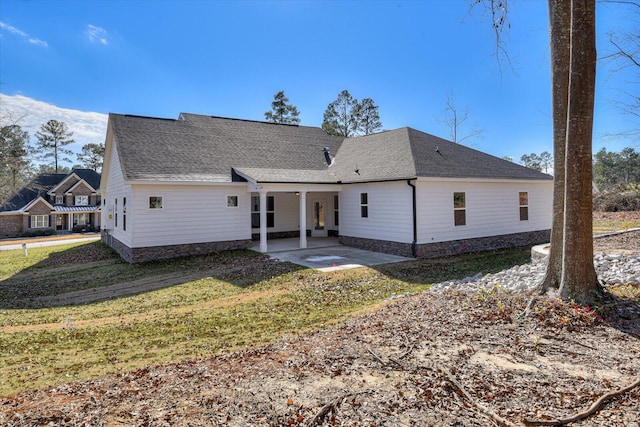 rear view of house featuring a yard and a patio area