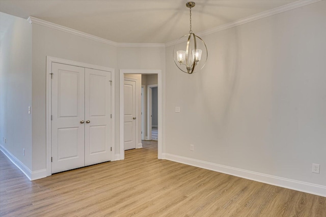 interior space with crown molding, a notable chandelier, and light wood-type flooring