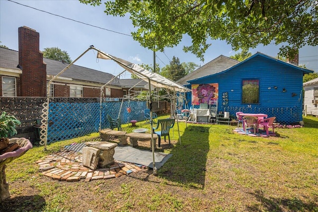 back of property with a lawn and a patio area