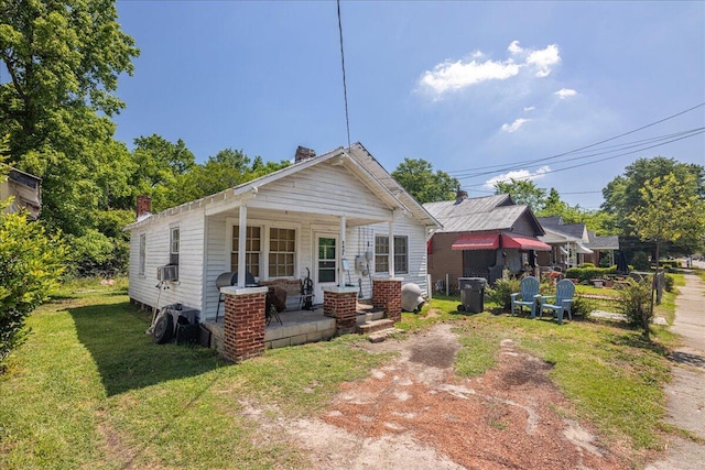 view of front of home featuring covered porch and a front yard