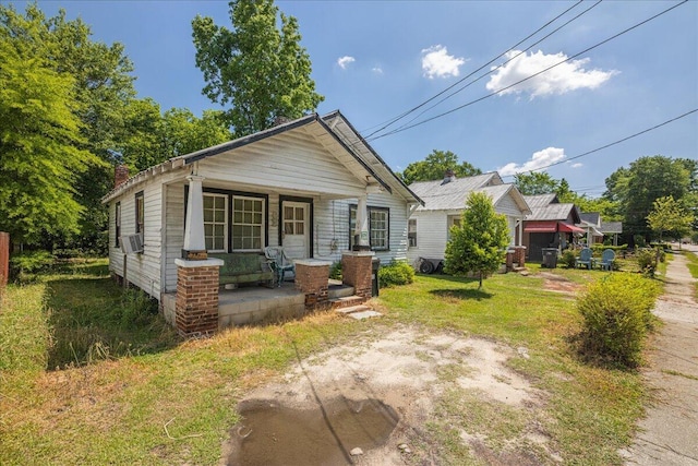 bungalow-style home with cooling unit and covered porch