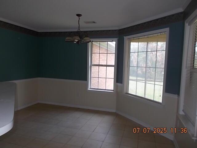 3938 Crest Dr, Hephzibah, GA 30815 - unfurnished dining area with a chandelier, crown molding, and light tile patterned floors