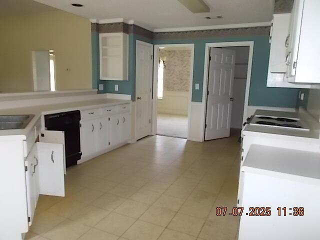 3938 Crest Dr, Hephzibah, GA 30815 - kitchen with black dishwasher, white cabinets, stove, and light countertops