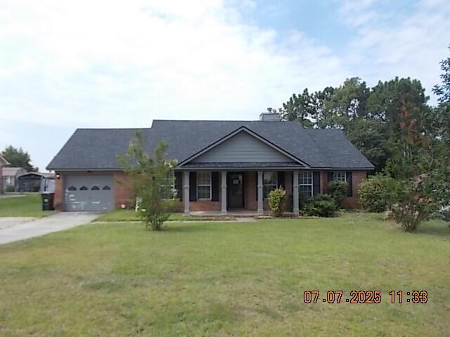 3938 Crest Dr, Hephzibah, GA 30815 - view of front of home with covered porch, driveway, a garage, and a front yard