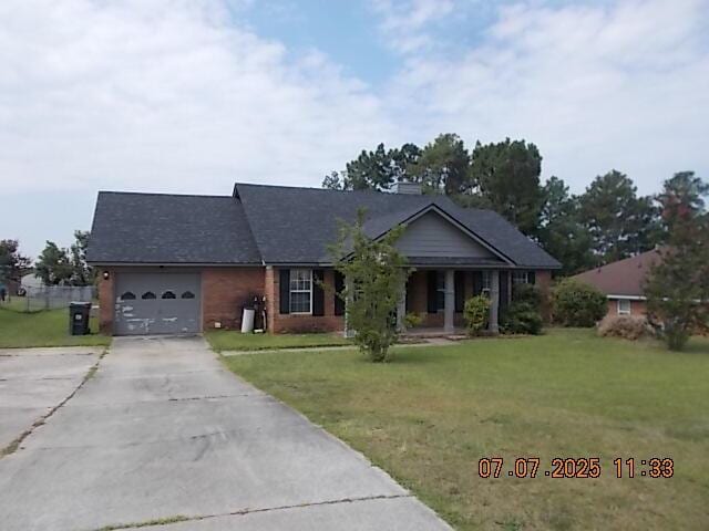 3938 Crest Dr, Hephzibah, GA 30815 - single story home with concrete driveway, a front yard, an attached garage, and a porch
