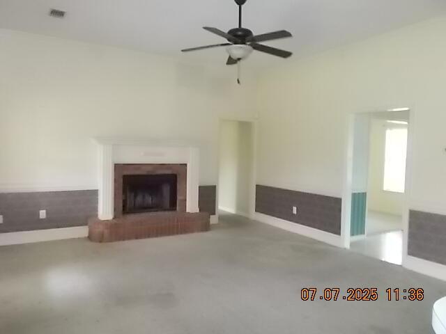 3938 Crest Dr, Hephzibah, GA 30815 - unfurnished living room with a fireplace and a ceiling fan