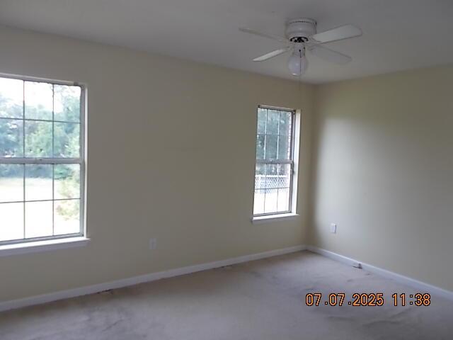 3938 Crest Dr, Hephzibah, GA 30815 - empty room with light colored carpet, healthy amount of natural light, and a ceiling fan