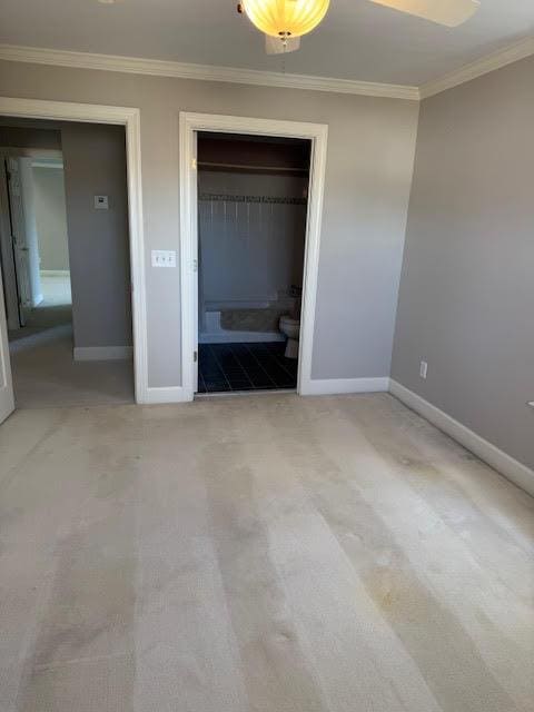 unfurnished bedroom with light colored carpet and ornamental molding