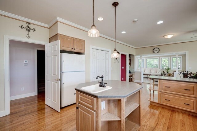 kitchen with sink, crown molding, a center island, light brown cabinets, and white fridge