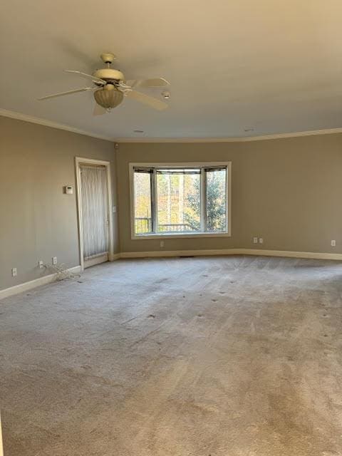 carpeted empty room featuring crown molding and ceiling fan