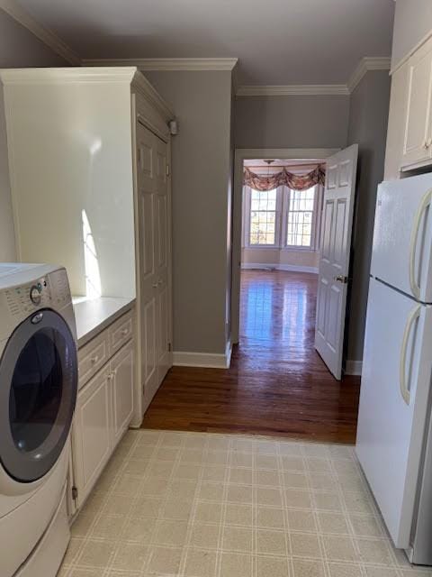 laundry area with crown molding, washer / dryer, and light wood-type flooring