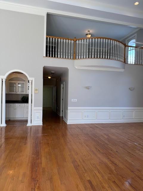 interior space with hardwood / wood-style flooring and a towering ceiling