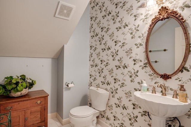 bathroom featuring sink, toilet, and tile patterned flooring