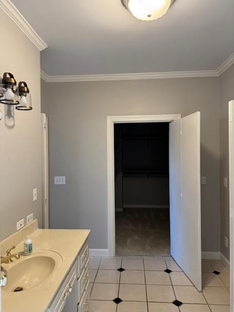 bathroom with tile patterned flooring, crown molding, and vanity