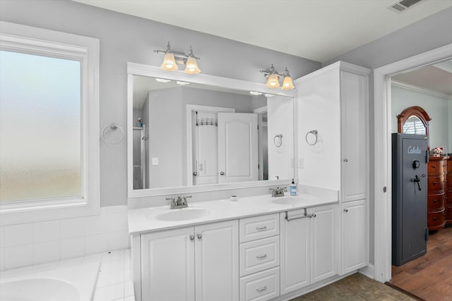 full bath with double vanity, visible vents, and a sink