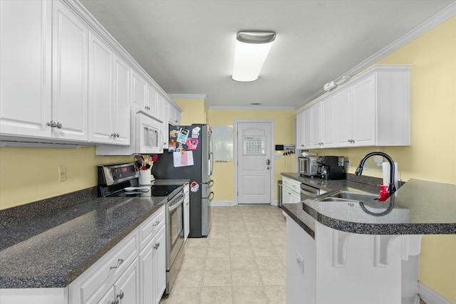 kitchen with white cabinets, appliances with stainless steel finishes, crown molding, and a sink