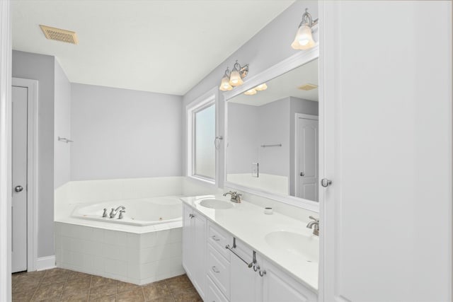 full bath with double vanity, a jetted tub, visible vents, and a sink