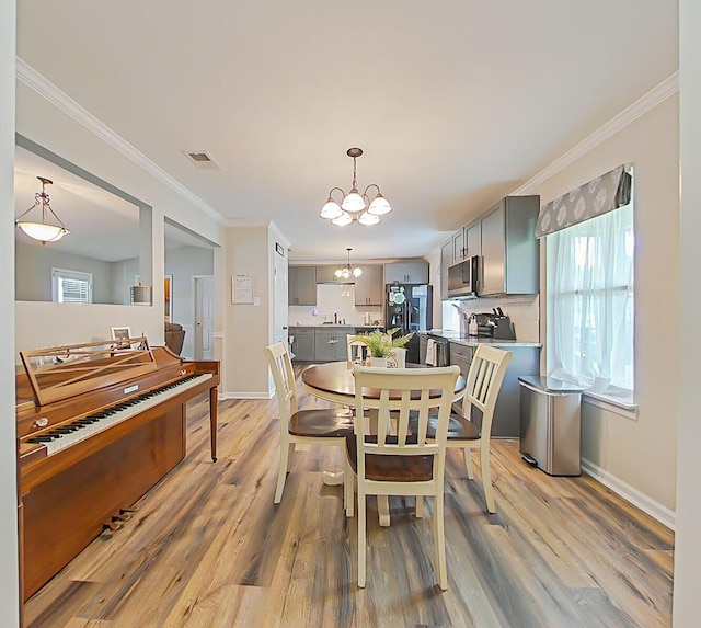 620 W Clinton Way, Martinez, GA 30907 - dining area featuring a chandelier, light wood finished floors, ornamental molding, and baseboards