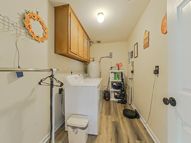 620 W Clinton Way, Martinez, GA 30907 - washroom with cabinet space, washer and clothes dryer, and light wood-style floors