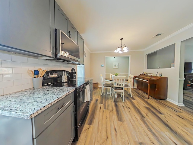 620 W Clinton Way, Martinez, GA 30907 - kitchen featuring black electric range oven, stainless steel microwave, crown molding, backsplash, and gray cabinetry