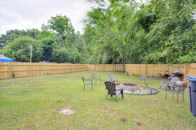 view of yard with a fire pit