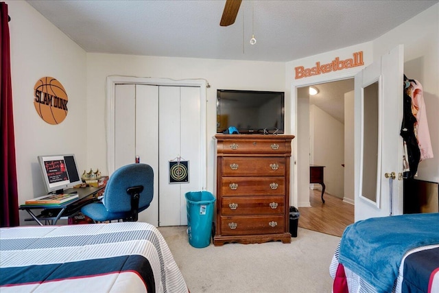 carpeted bedroom with a closet and a ceiling fan
