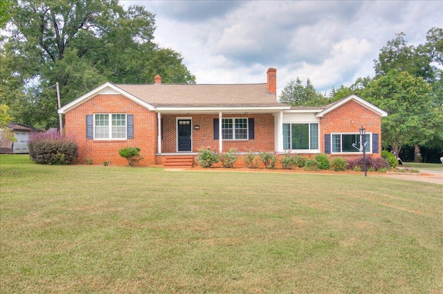 ranch-style home featuring a porch and a front yard