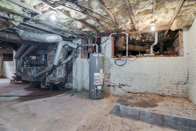 basement featuring water heater and brick wall