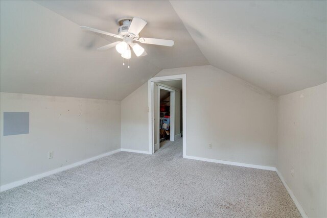 additional living space featuring light carpet, vaulted ceiling, and ceiling fan