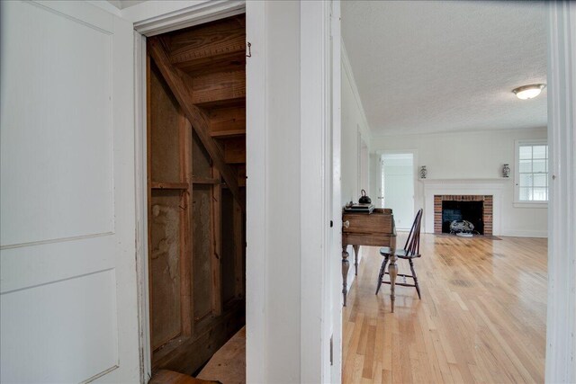 corridor with wood-type flooring and a textured ceiling