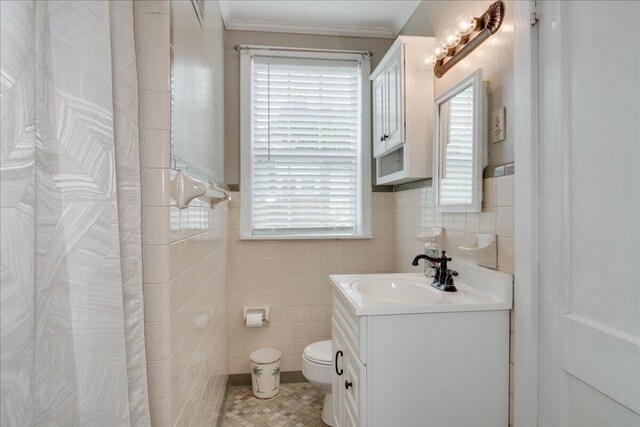 bathroom with vanity, ornamental molding, tile walls, and toilet