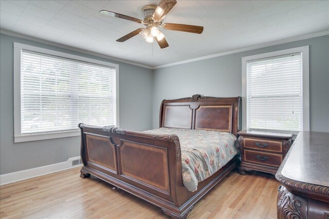 bedroom with light wood-type flooring, ceiling fan, and crown molding