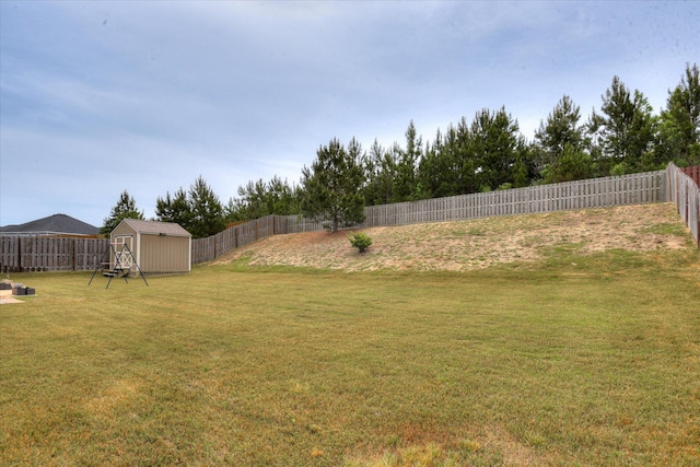 view of yard featuring an outbuilding, a shed, and a fenced backyard