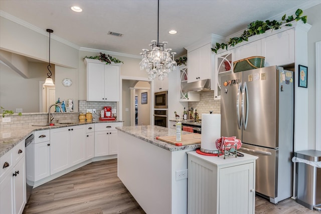 kitchen featuring a sink, under cabinet range hood, a center island, backsplash, and appliances with stainless steel finishes