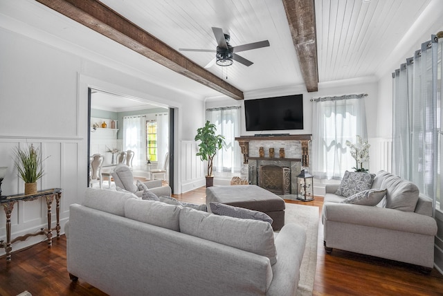 living room with a fireplace, wood ceiling, ceiling fan, dark wood-type flooring, and beamed ceiling